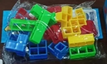 Plastic balance stacking board game with 16 coloured building blocks, chassis, and base on table.
