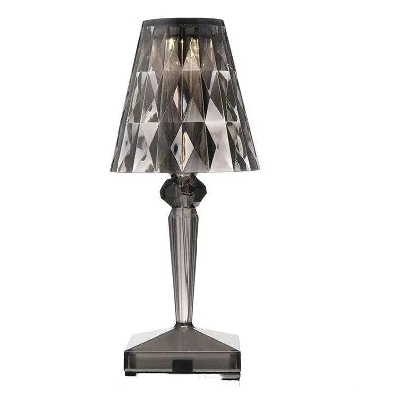 Rose gold portable touch control night light with dimming settings on a surface.