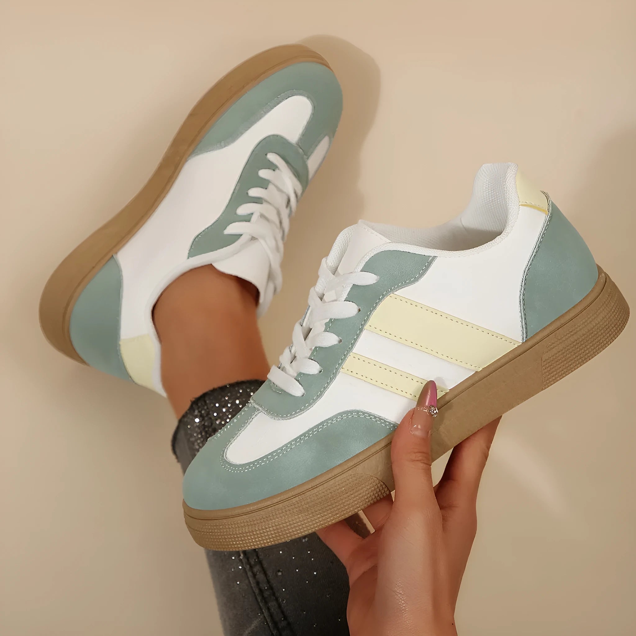 Green retro sports women's pumps with cross straps, leather stitching, round toe, and a low flat rubber sole.