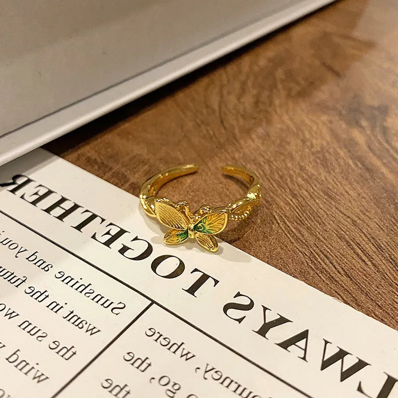 Copper butterfly women's ring with oil-drip finish showing open-loop design