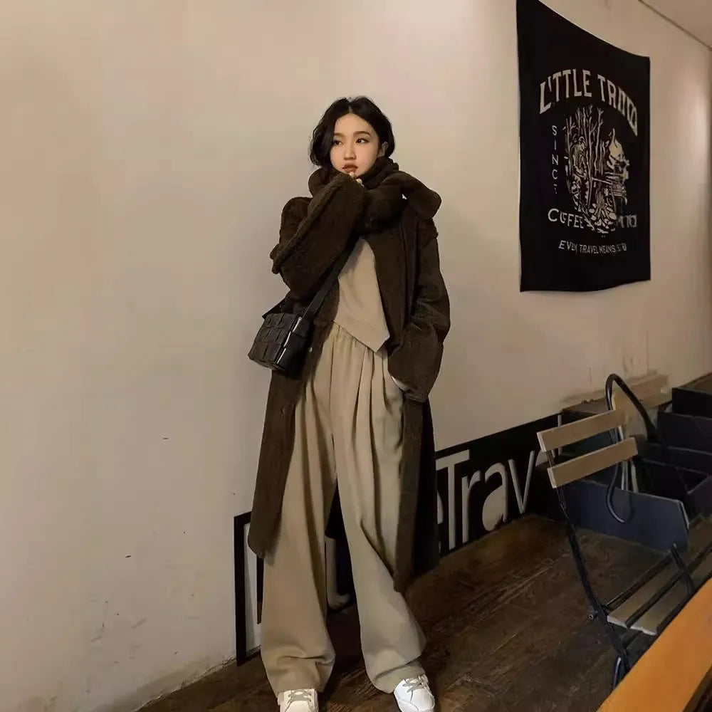 Women's khaki loose-fit casual sports suit with long sleeve top and trousers on a hanger.