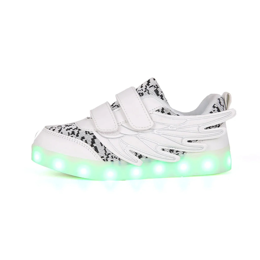 Plum red children's sneakers with LED lights glowing on the soles, showing USB charging port.