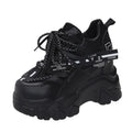 Women's white mesh platform sports shoes with cross strap and a high rubber sole.