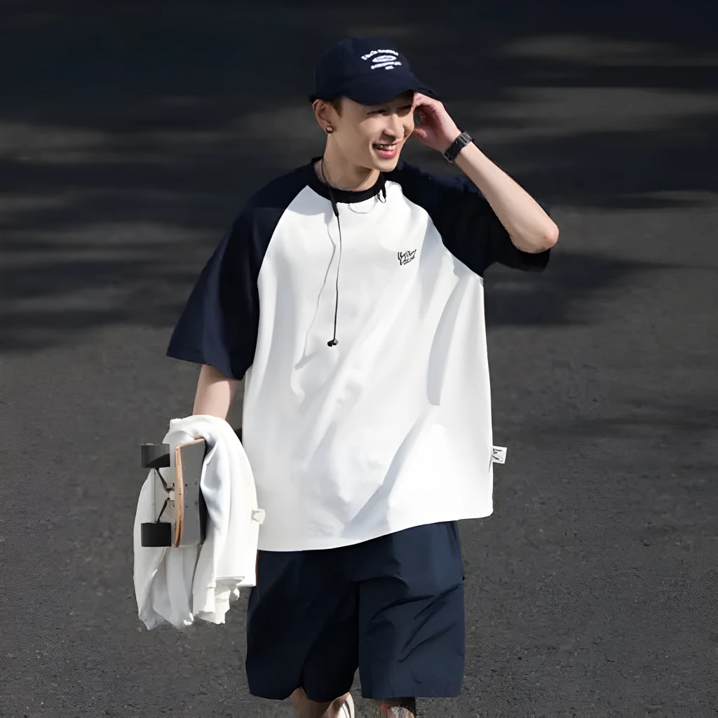 Man wearing a loose blue raglan sleeve casual t-shirt, Japanese style, thin polyester blend.
