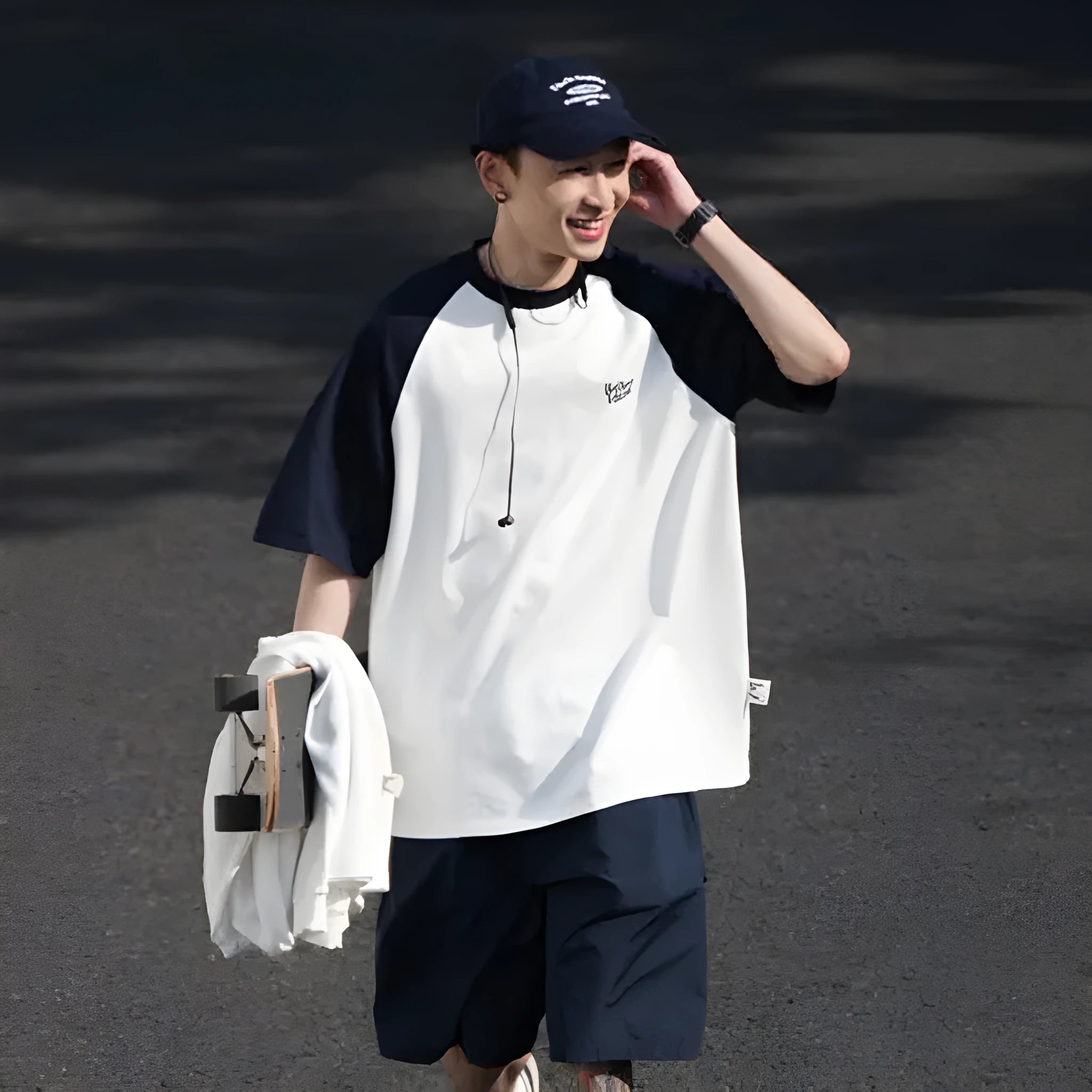 Man wearing a loose blue raglan sleeve casual t-shirt, Japanese style, thin polyester blend.