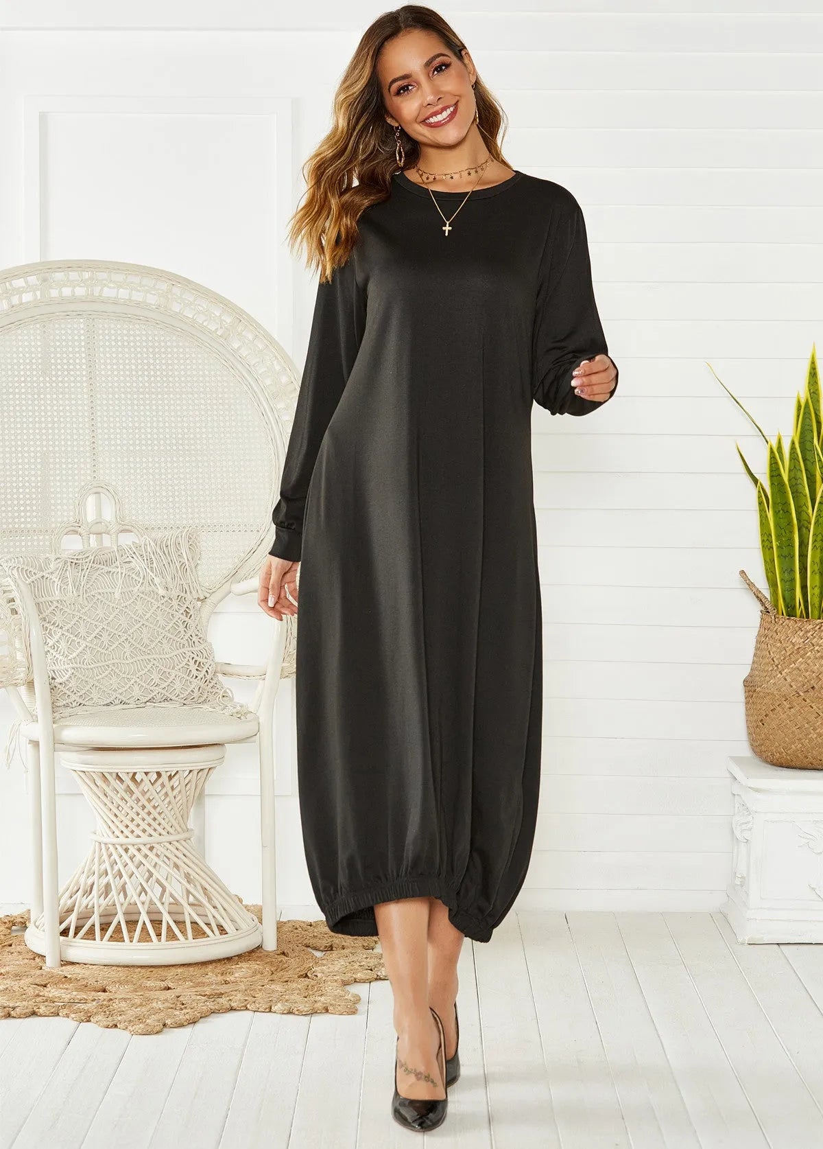 Black knitted lantern dress with loose fit sleeves and lace-up front detail on a mannequin.