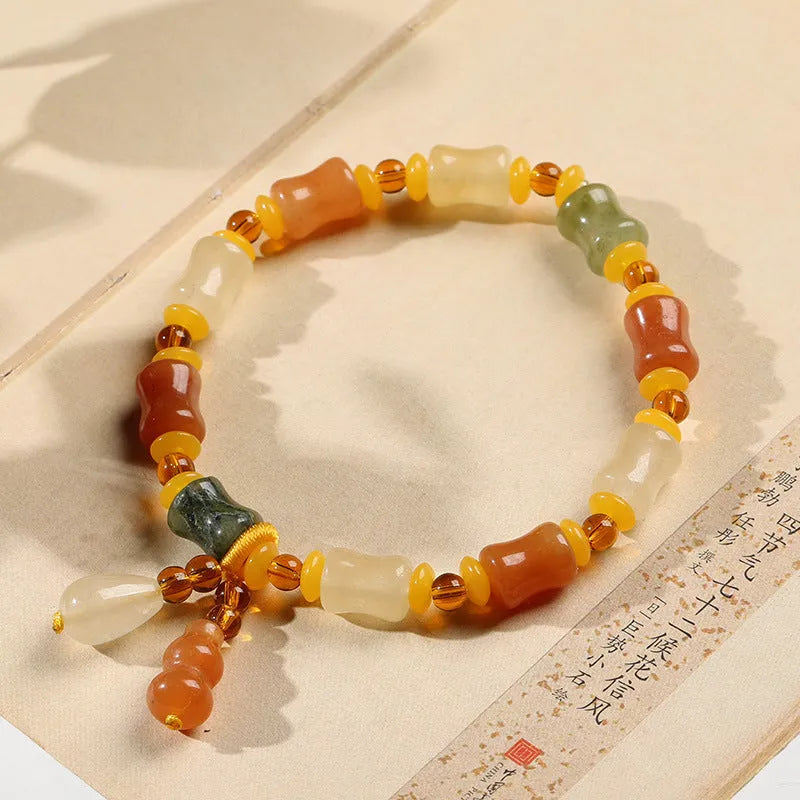 Jinsi Jade bracelet with small bone beads showing auspicious patterns and geometric design