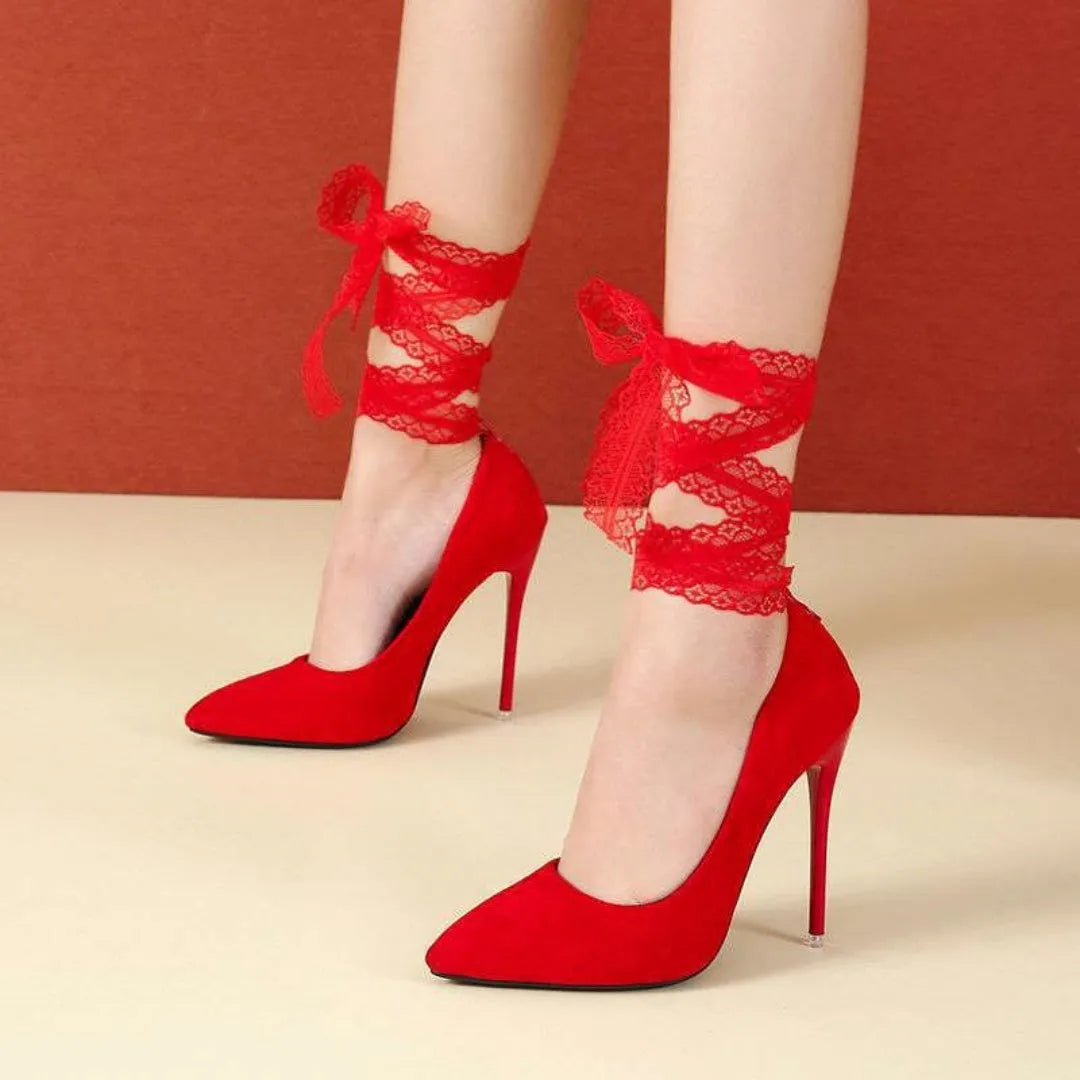 Black women's high heel court shoe with pointed toe and fabric ankle strap on a flat buckle.
