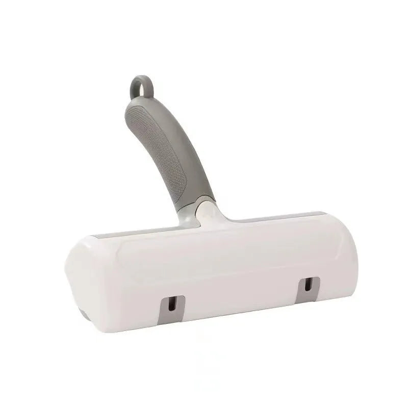 Mint green manual brush for removing cat hair from furniture and fabrics, showing its size.