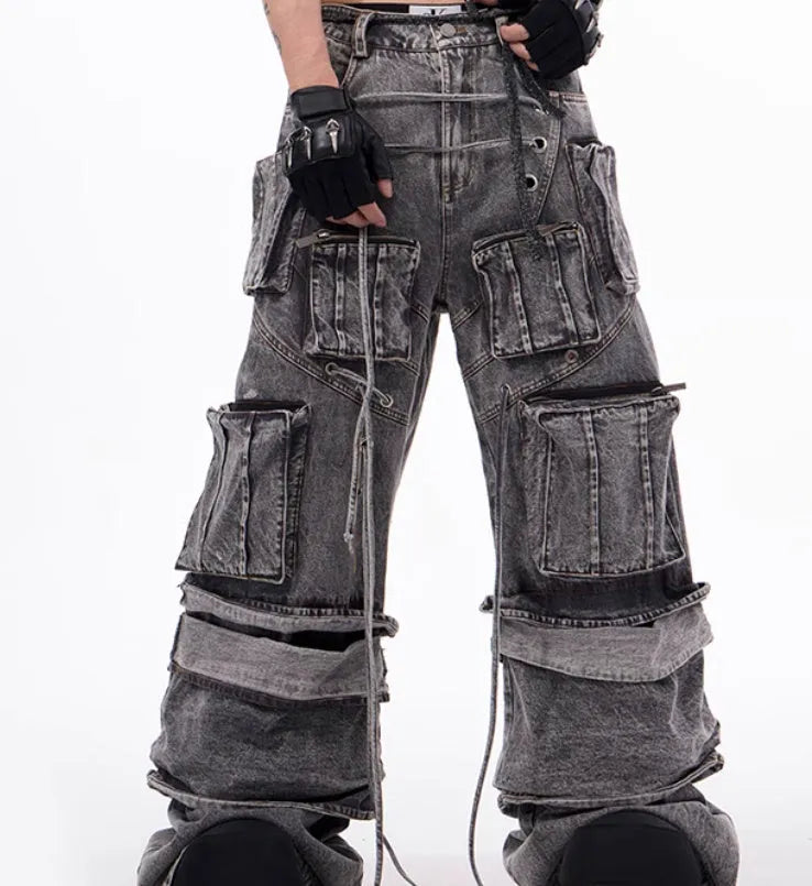 Grey distressed denim overalls with rope stitching detail on front
