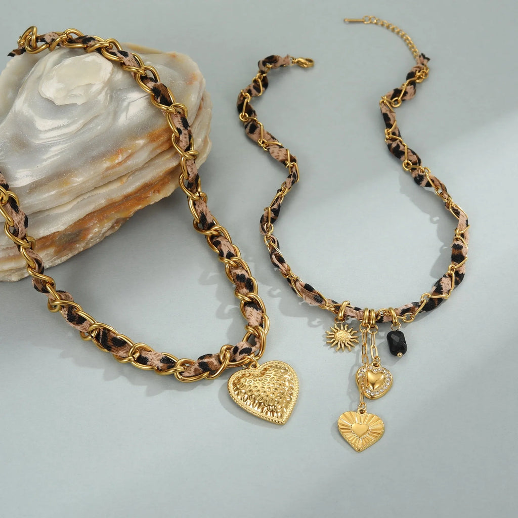Leopard Love stainless steel necklace with 18K gold plating, showing geometric Big Heart or Love Sun pendant on an adjustable chain.