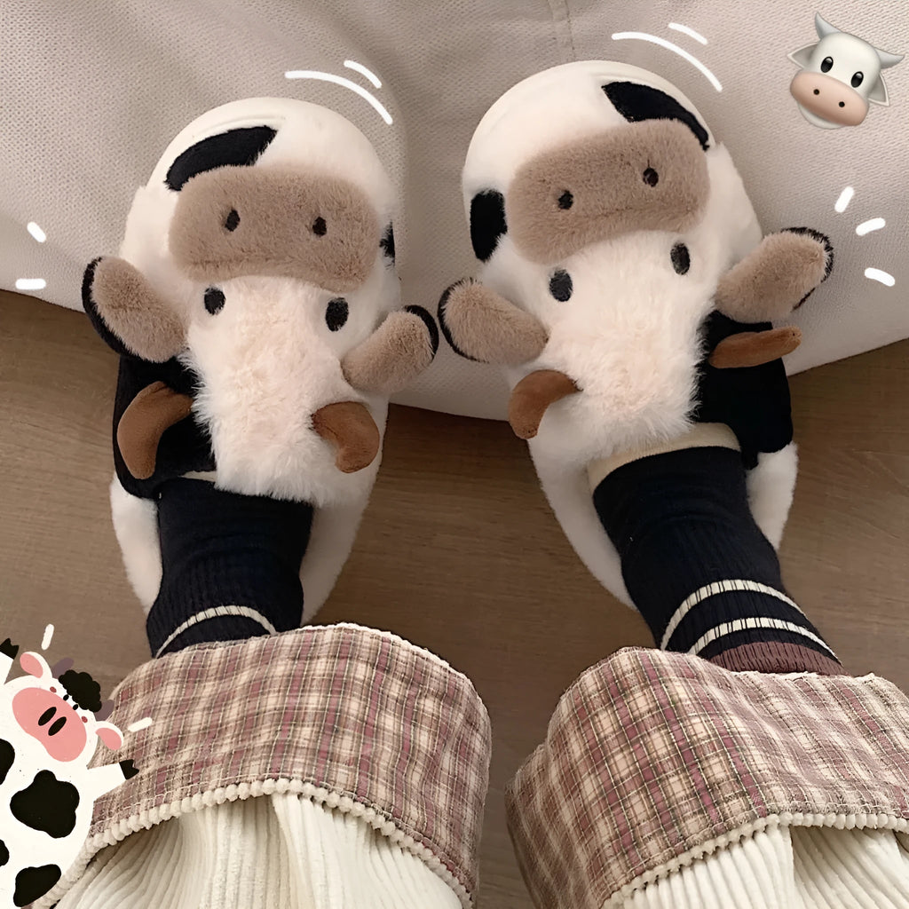 White cartoon cow design faux fur slippers for women with a non-slip textured sole.