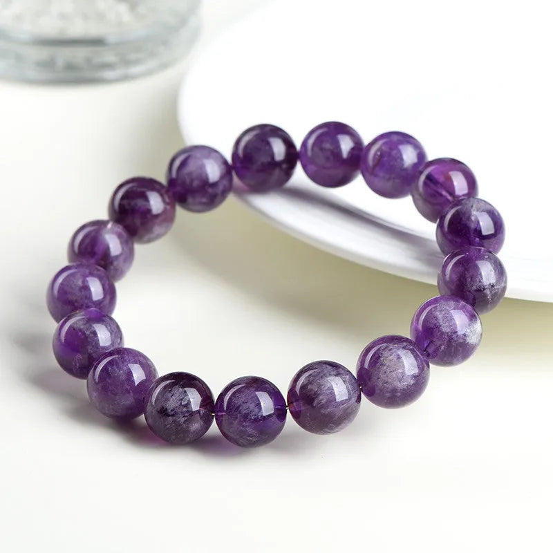 Natural feather amethyst crystal bracelet with scattered beads and a Ruyi symbol in Snow Mountain purple.