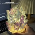 Butterfly-shaped night lamp with glass lampshade on raw wood base