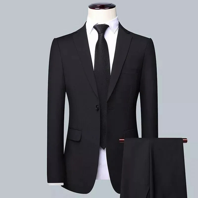 Men's slim fit three-piece suit set in black, including jacket, trousers, and tie on a hanger.