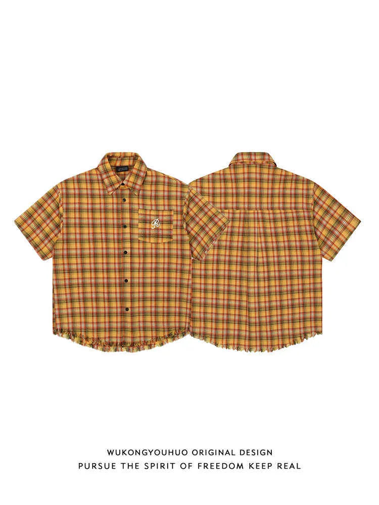 Yellow and white grid pattern short sleeve shirt with loose fit and embroidered chest pocket.