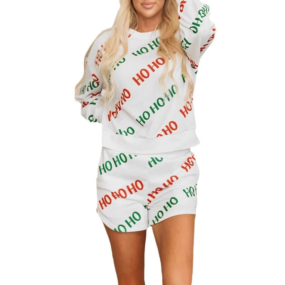 White women's two-piece suit with printed letter design on long-sleeve top and fifth-length trousers.