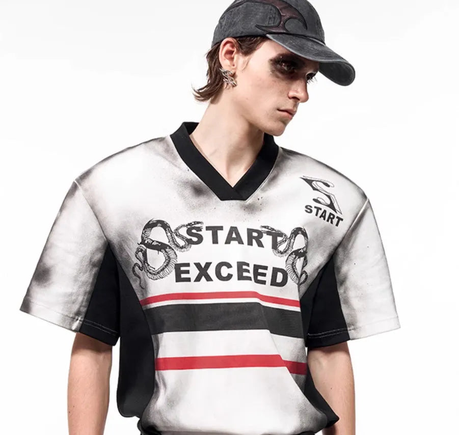 Women's short sleeve V-neck top with a black and white letter snake pattern print and padded shoulders.