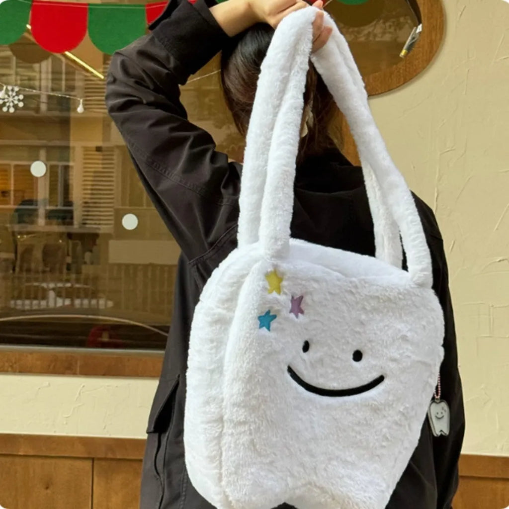 White plush shoulder tote bag with a large capacity and playful cute teeth design, shown with a crossbody strap.