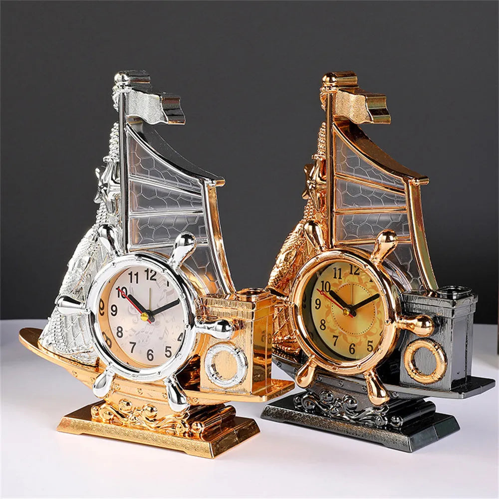 Modern metallic-finish bedroom alarm clock in gold or silver on a bedside table.