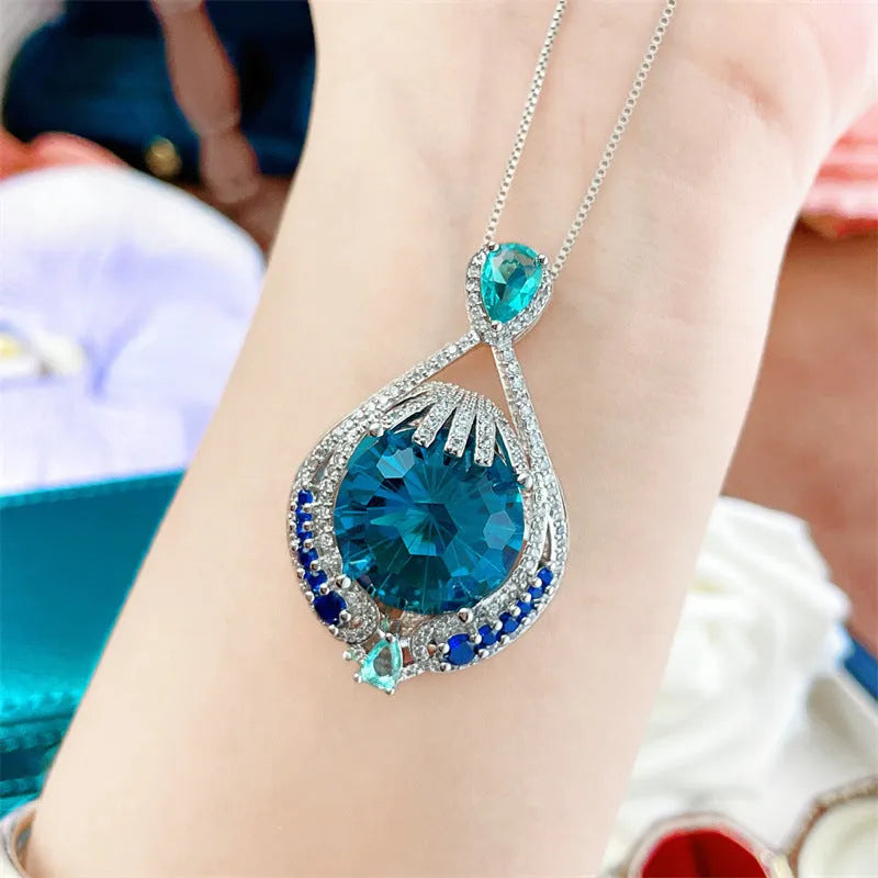 Geometric women's necklace with blue crystal fireworks cut pendant on water wave chain