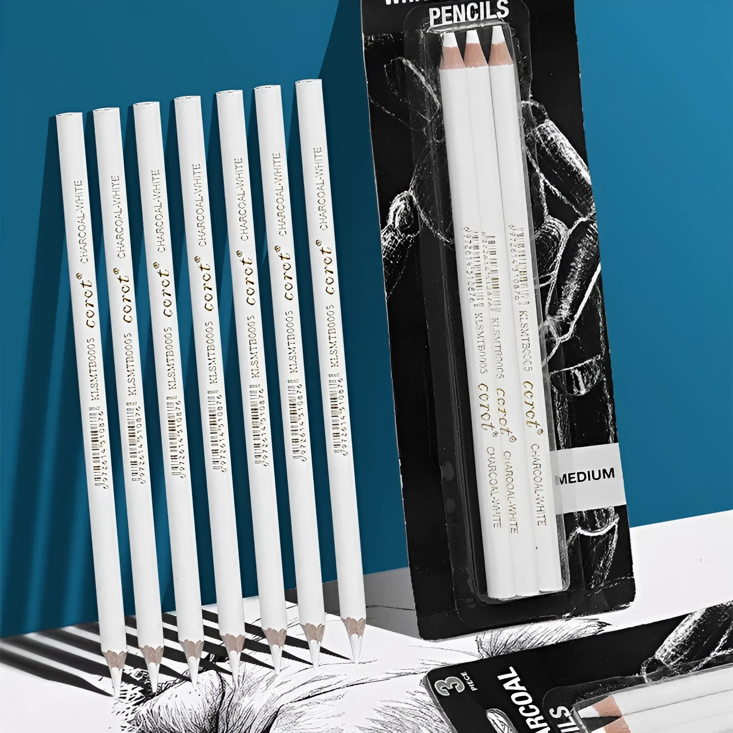 Set of three white charcoal drawing pencils with wooden barrels for sketching on dark paper.