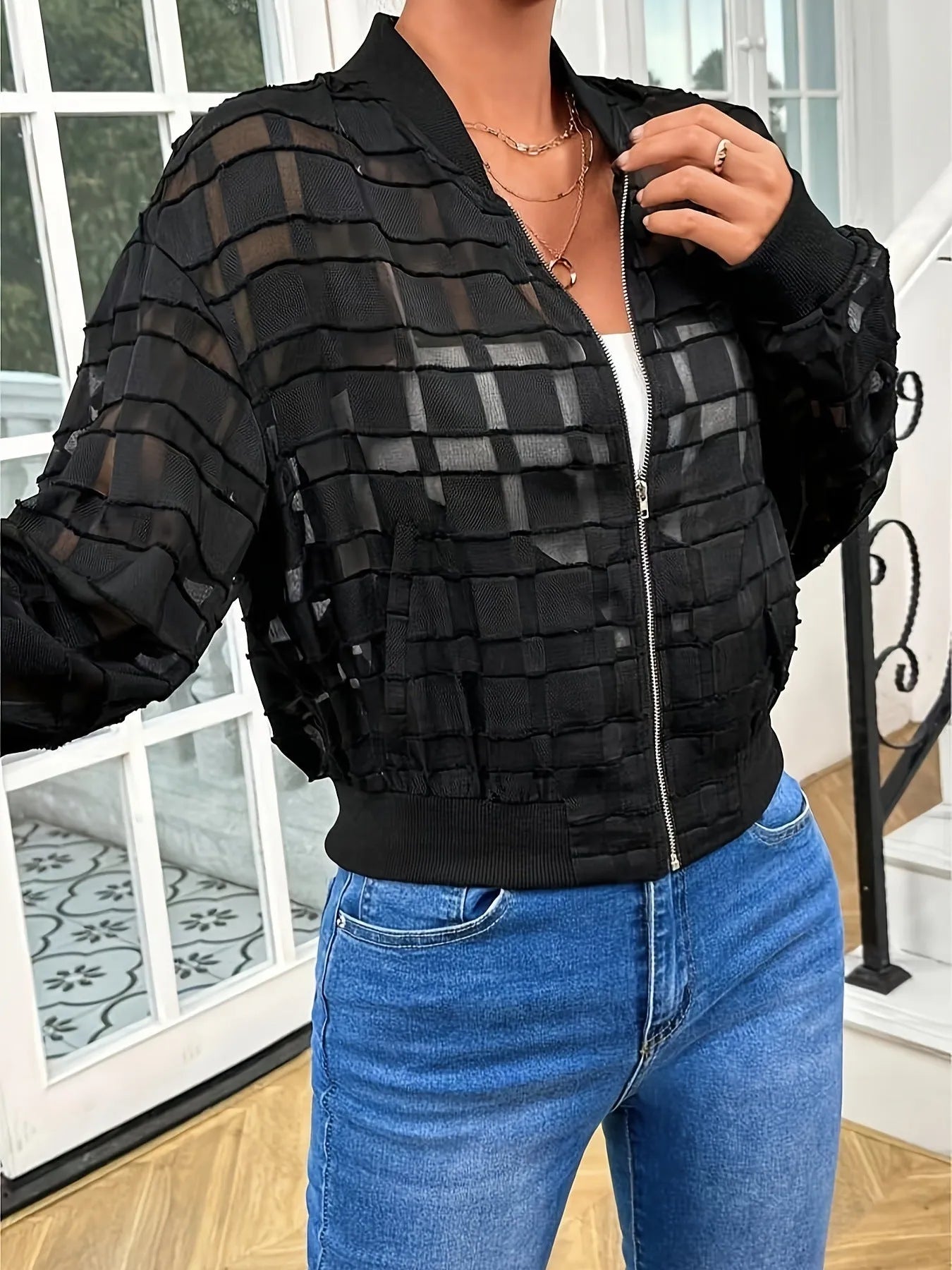 Black women's casual jacket with geometric pattern and semi-transparent thread detail, zip front.