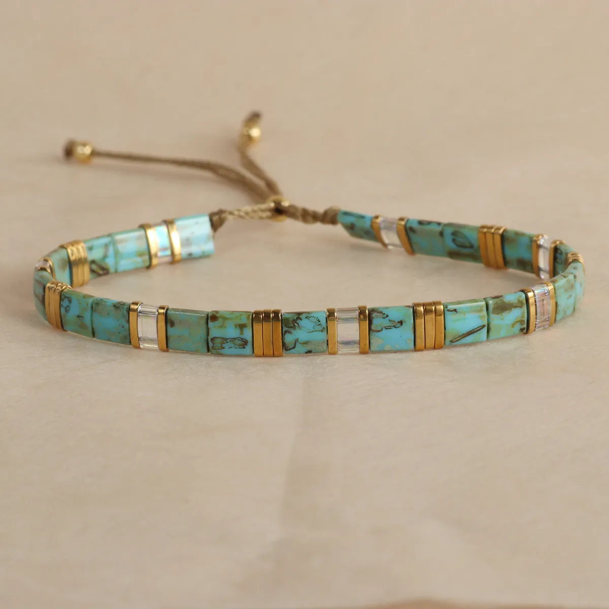 Geometric round glass bead bracelet in milky white, black, green, blue, or red.