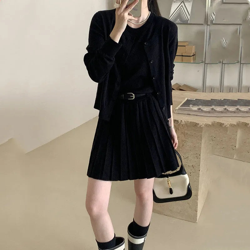 Grey art retro women's knitted cardigan and pleated vest skirt set with a waist belt.