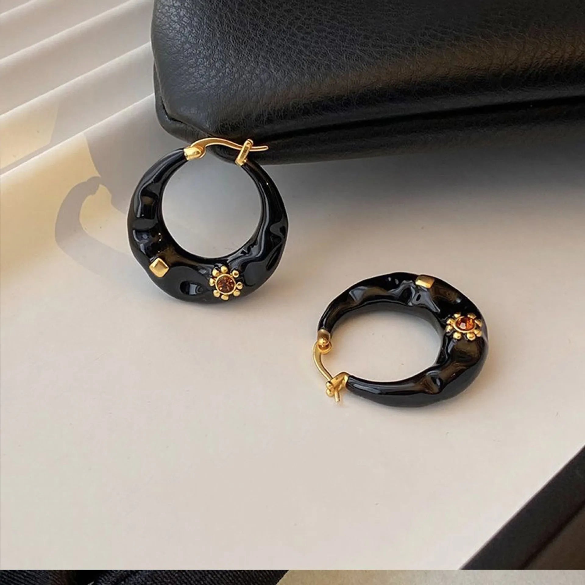 Black and red alloy ear studs with rhinestone inlays and dripping oil textured surface