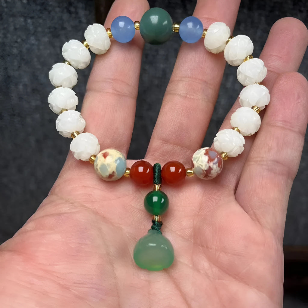 Carved Bodhi root bracelet with white jade, lotus, and pumpkin beads in various sizes.