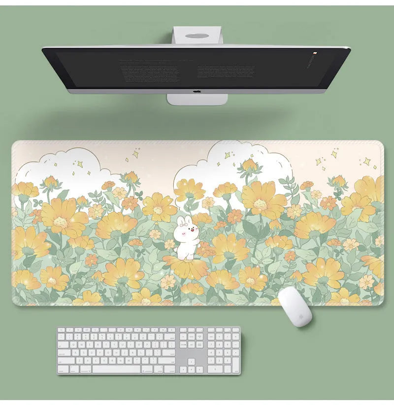 Large floral pattern mouse pad on a desk with keyboard and mouse, showing non-slip rubber base.