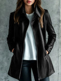 Black polyester women's leather jacket with long sleeves on a hanger.