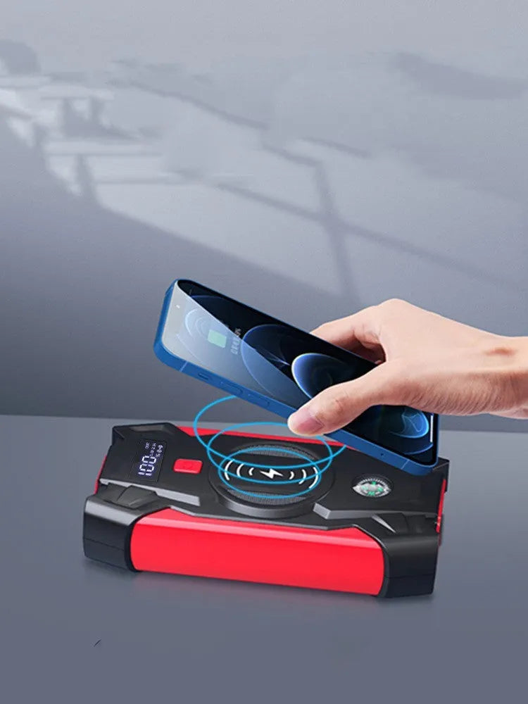 Red car emergency jump starter with digital display and battery clips showing 39800A peak current