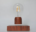 Magnetic levitation floating bulb lamp with imitation wood base and glass construction