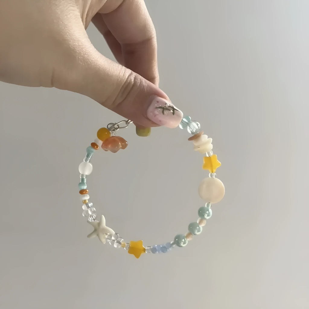 Orange alloy bracelet with diamond shape and round seawater-themed decorative elements