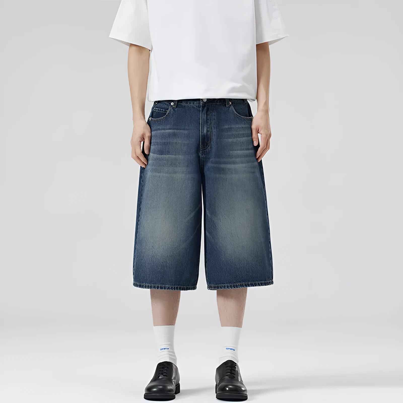 Men's straight leg cropped denim shorts in light blue, shown laid flat.