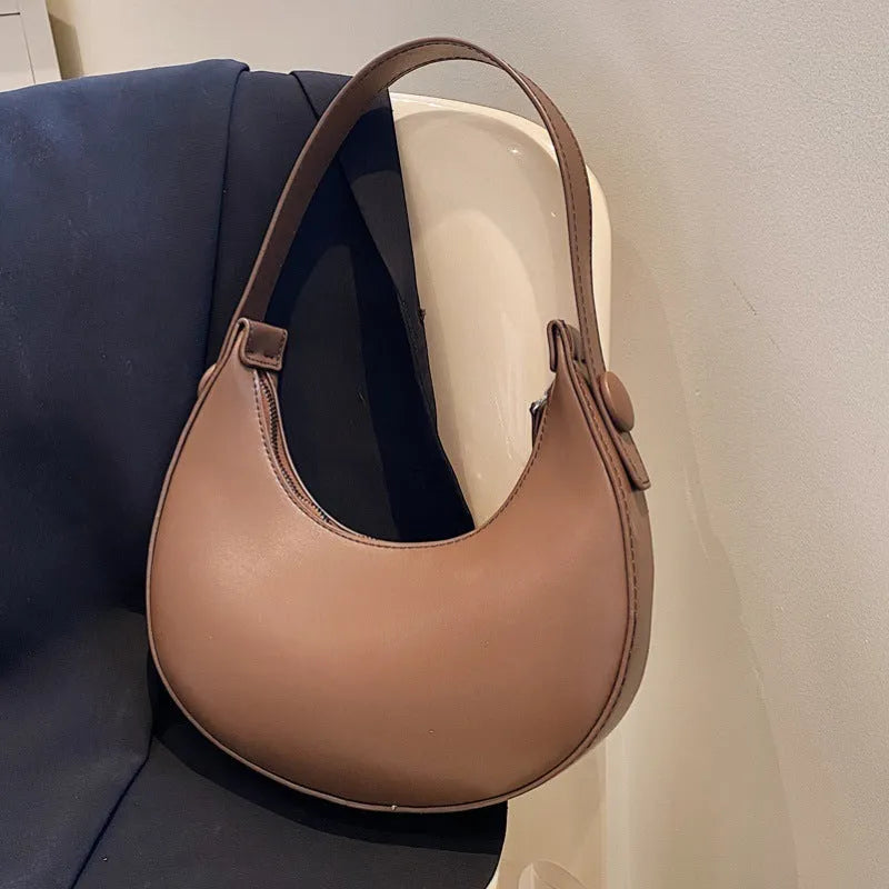 Retro-style women's dumpling-shaped shoulder bag in PU, shown in one of four colours.