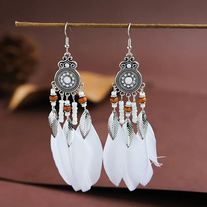 Round drop feather earrings with leaf patterning in alloy, available in multiple electroplated colours.