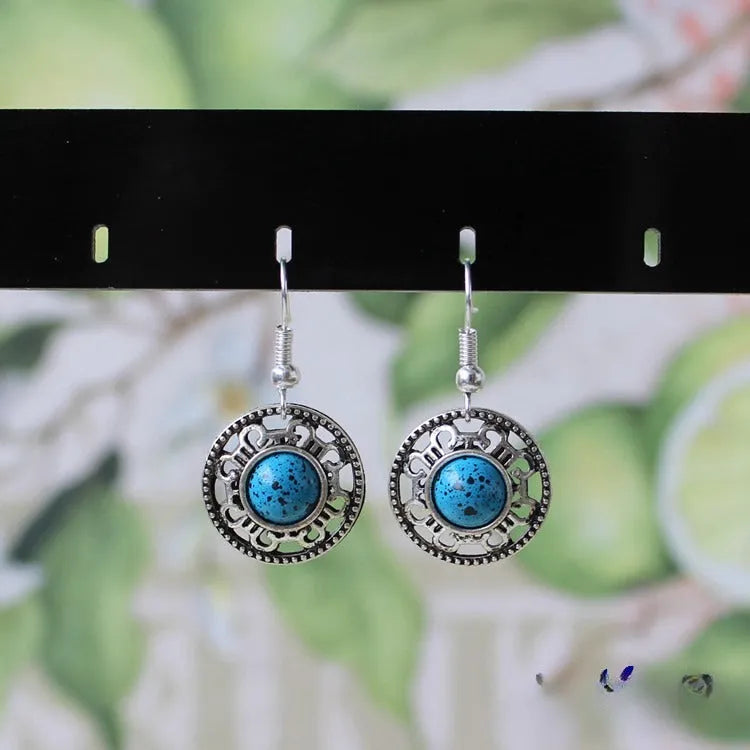 Miao ethnic silver earrings with geometric flower disk design and turquoise accents