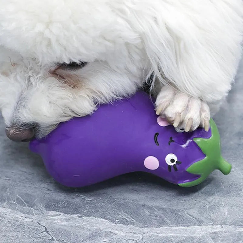 Green, orange, and purple latex vegetable dog chew toys with cartoon onion and eggplant designs