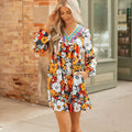 Orange floral print women's mini dress with V neck, long sleeves, and striped lace detail.