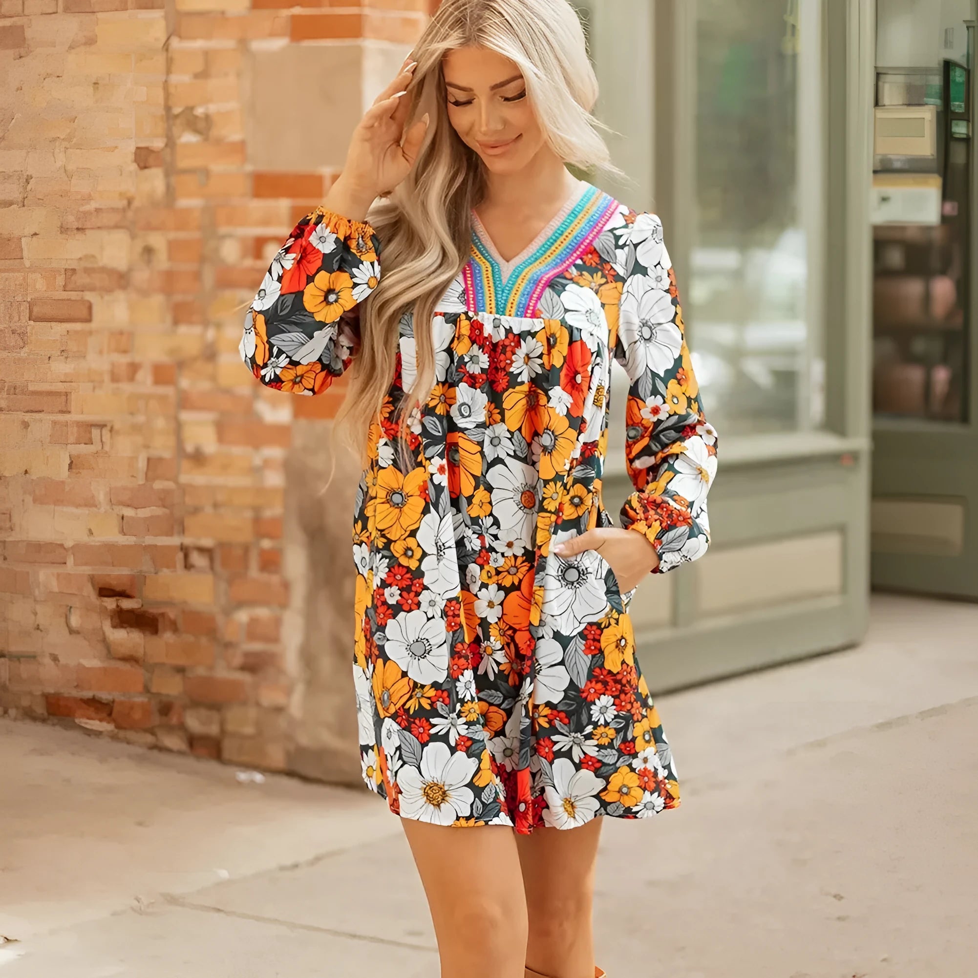 Orange floral print women's mini dress with V neck, long sleeves, and striped lace detail.