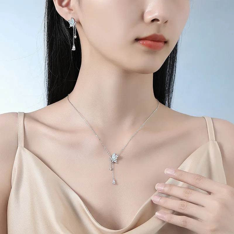Sterling silver S925 butterfly tassel necklace with noctilucent luminous pendant and adjustable O-ring chain on white background