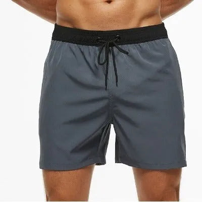 Men's blue athletic shorts with a stitching waistband, drawstring, and side headband pocket.