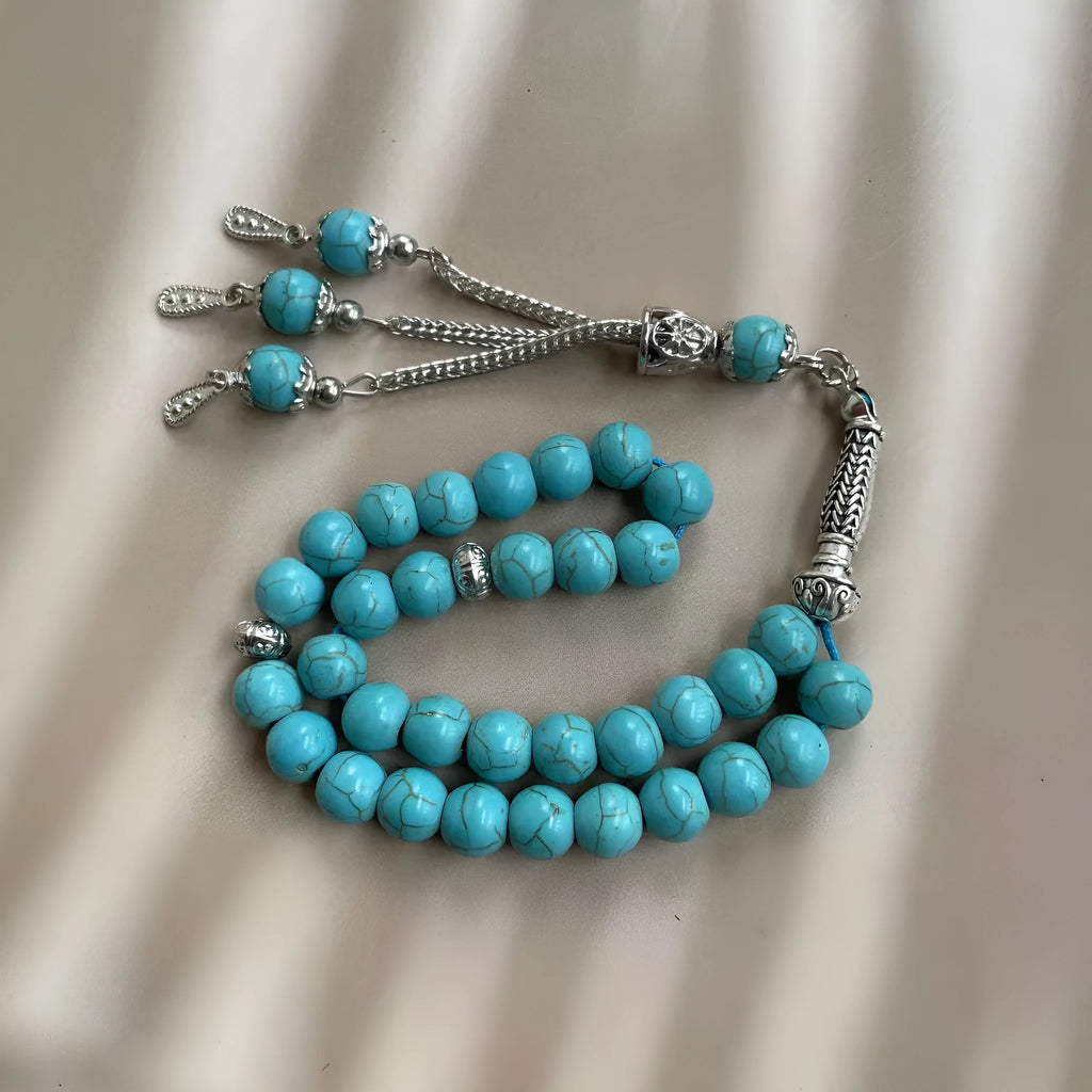 Handmade sky blue stone Muslim prayer bracelet with 8mm beads on a wrist.
