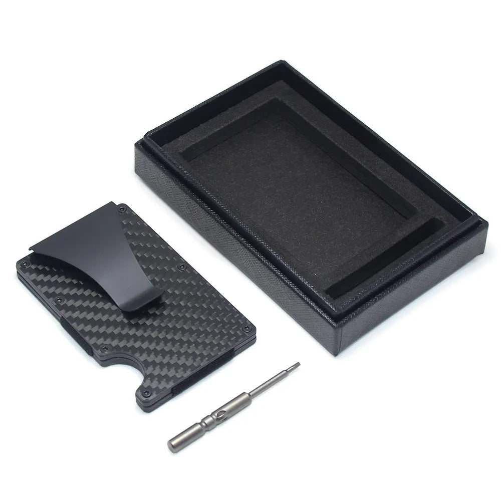 Slim black carbon fibre card holder wallet with geometric design on a table.