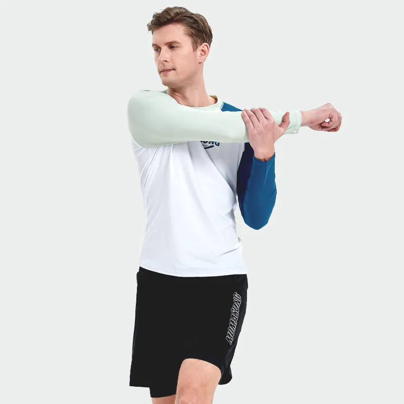 Men's white long-sleeved swim top with matching blue double-layer swim trunks on a beach.