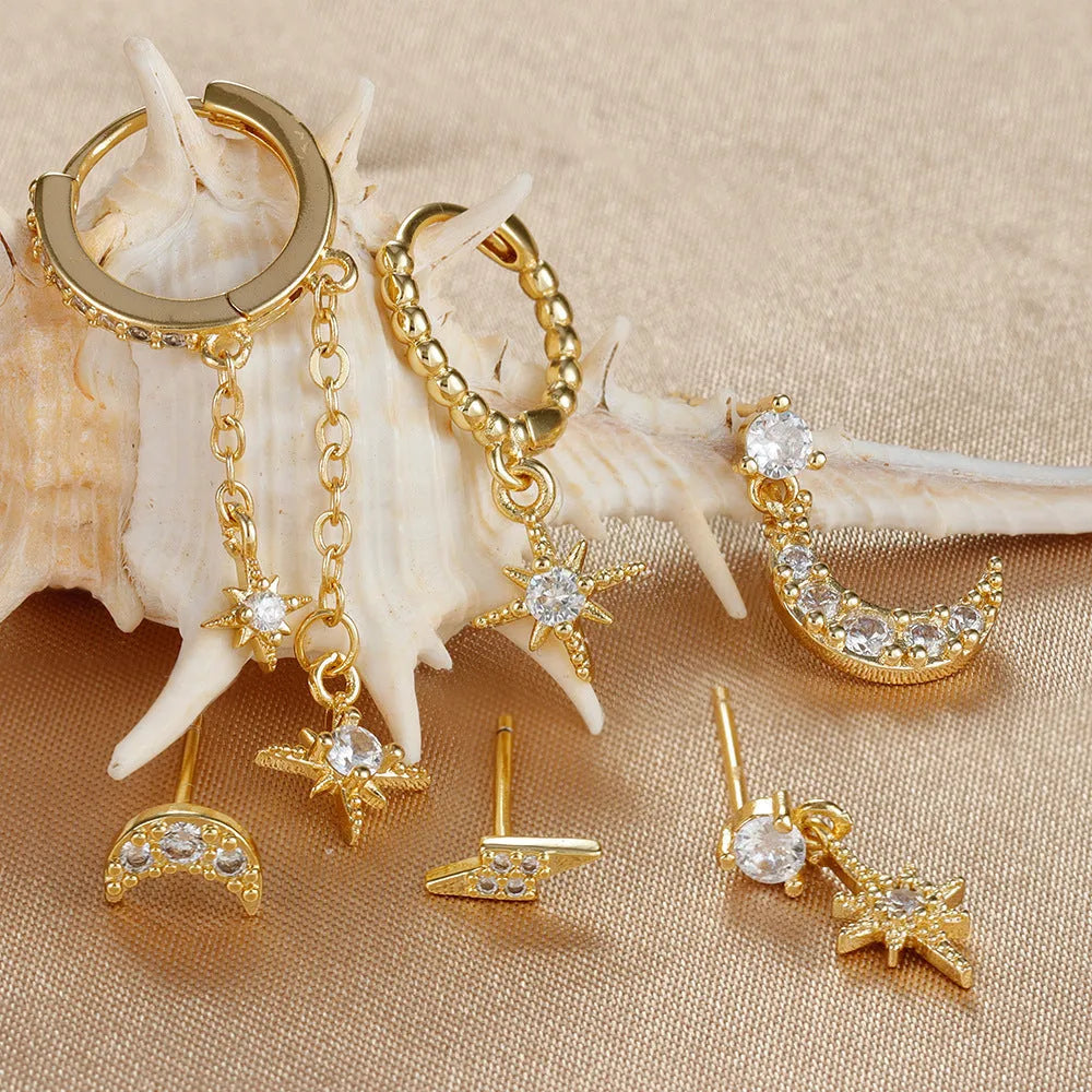 Six pairs of gold chain tassel earrings with zircon studs in display layout