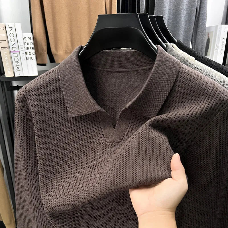 Men's loose green pullover sweater on a hanger, casual autumn wear